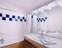 a room with a sink and a mirror